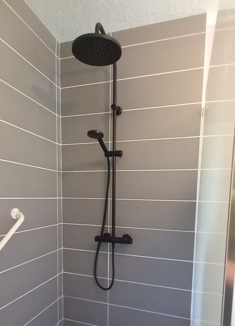 Douche contemporaine avec robinetterie noire mate installée par un plombier en Charente et Dordogne.